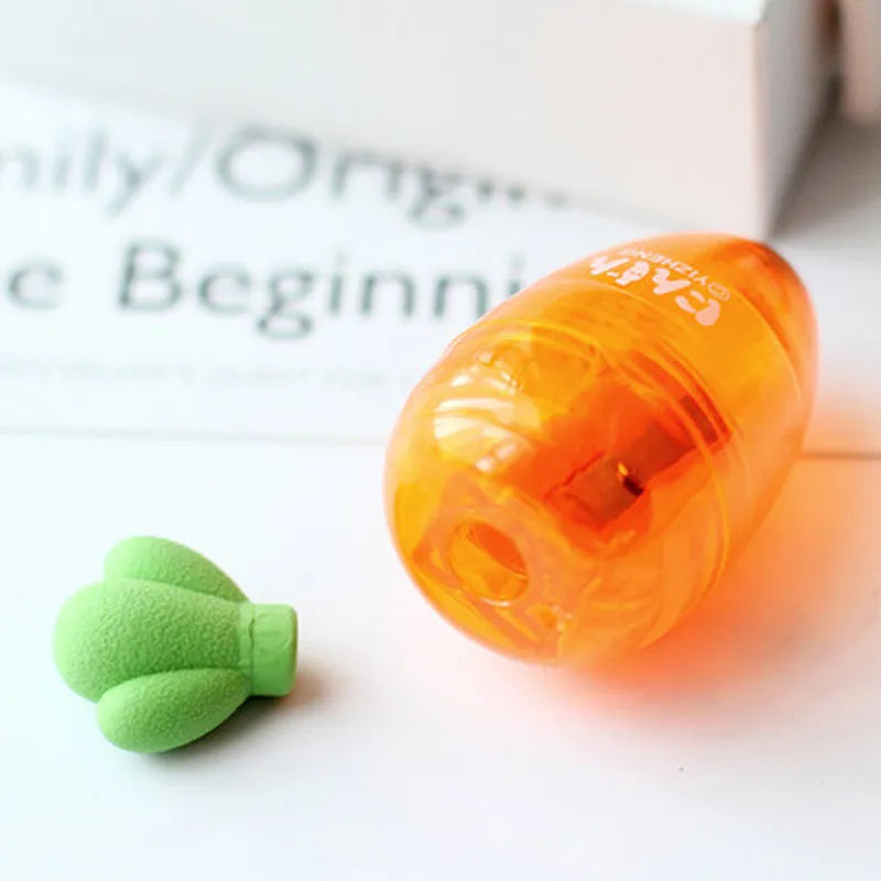 Carrot-shaped plastic pencil sharpener showing colourful design and 7cm length measurement