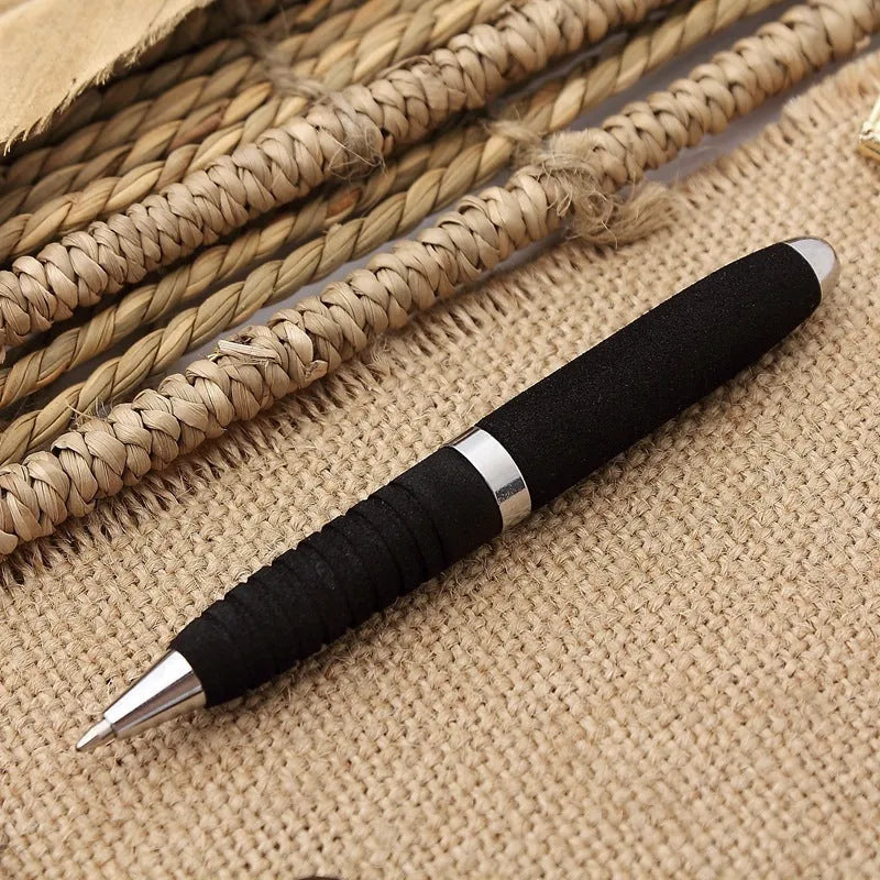 Silver EVA metal cap ballpoint pen with a 1.0mm tip on a notepad.