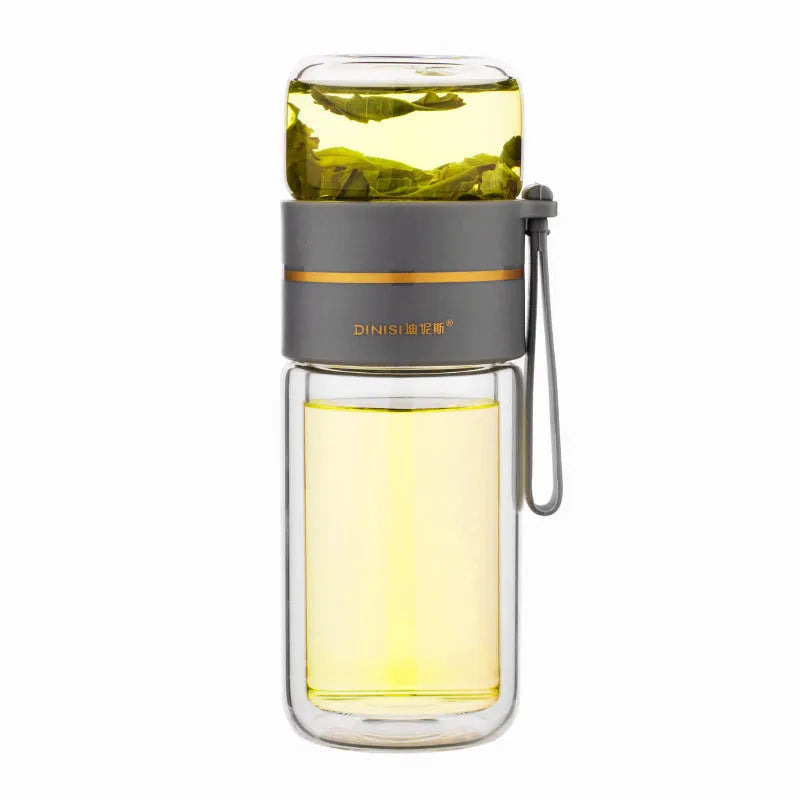 Green double-wall glass water bottle with a stainless steel tea infuser insert and a black leak-proof lid with rope handle.