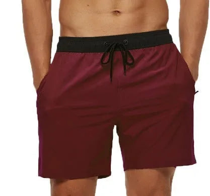 Men's blue stitching waist drawstring athletic shorts with a headband pocket and zipper fly.