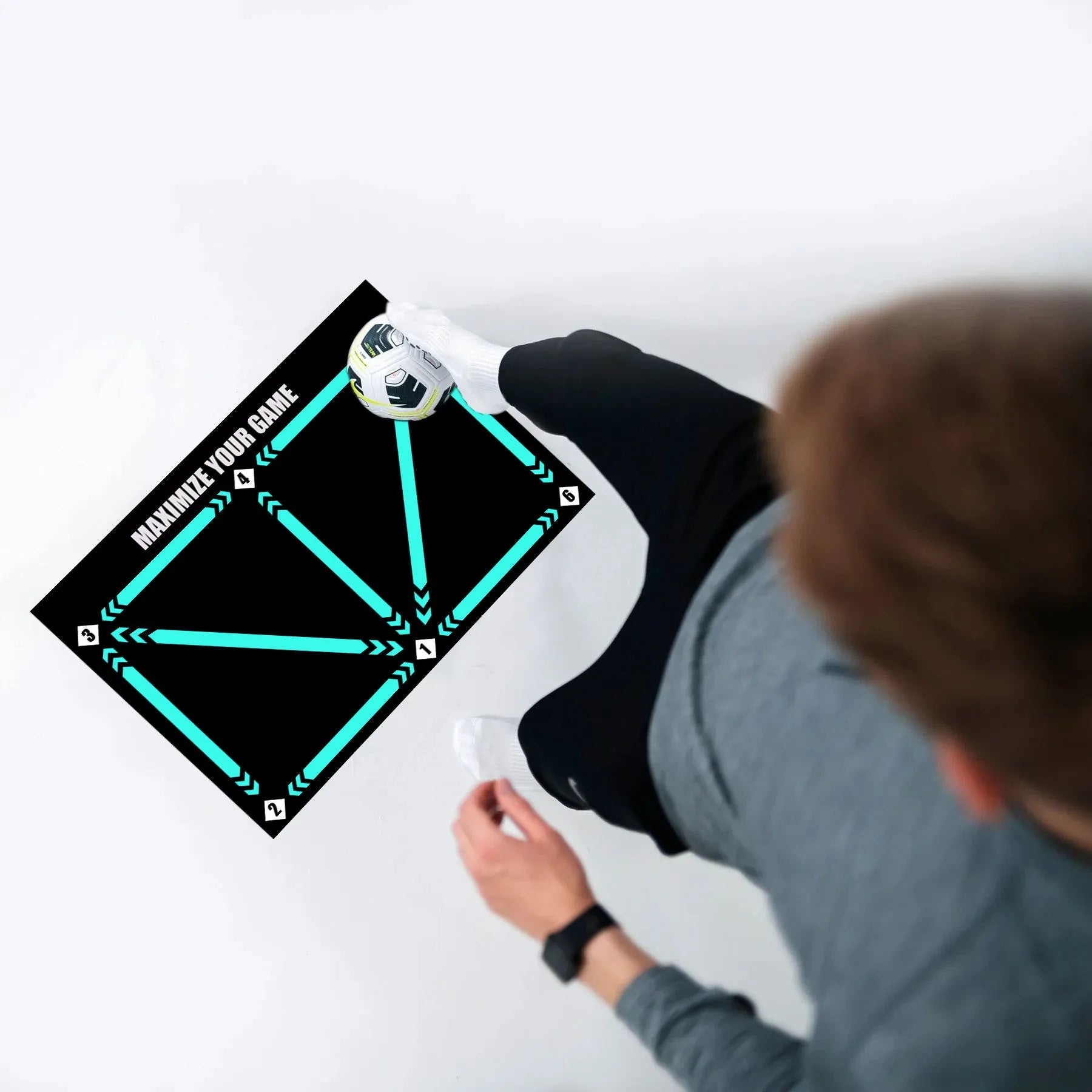 Black non-slip football training mat measuring 60cm by 90cm on a flat surface