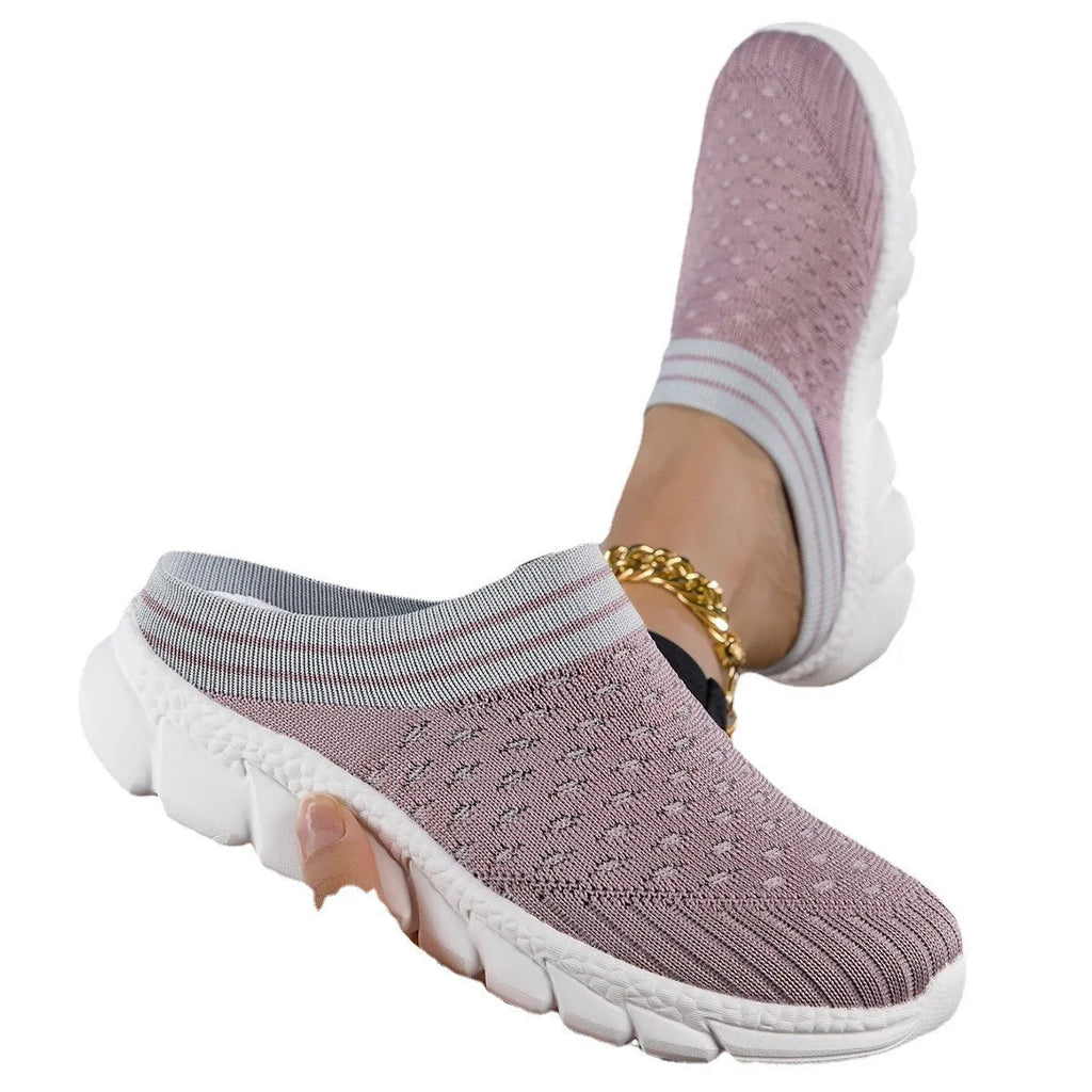 Women's black Flyknit semi-slipper casual shoe with striped pattern and hollow-out design on a white background.