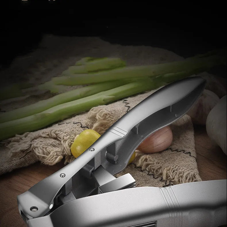 Silver aluminium alloy manual garlic press 20cm long on a white background