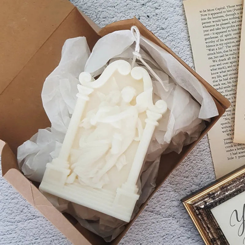 Square elf shaped silicone baking mold for angel aromatherapy candle ornaments and cake decorating on a plain background