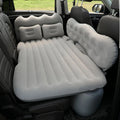 Inflatable car boot mattress with split design and grey flocked fabric, shown in an SUV rear.