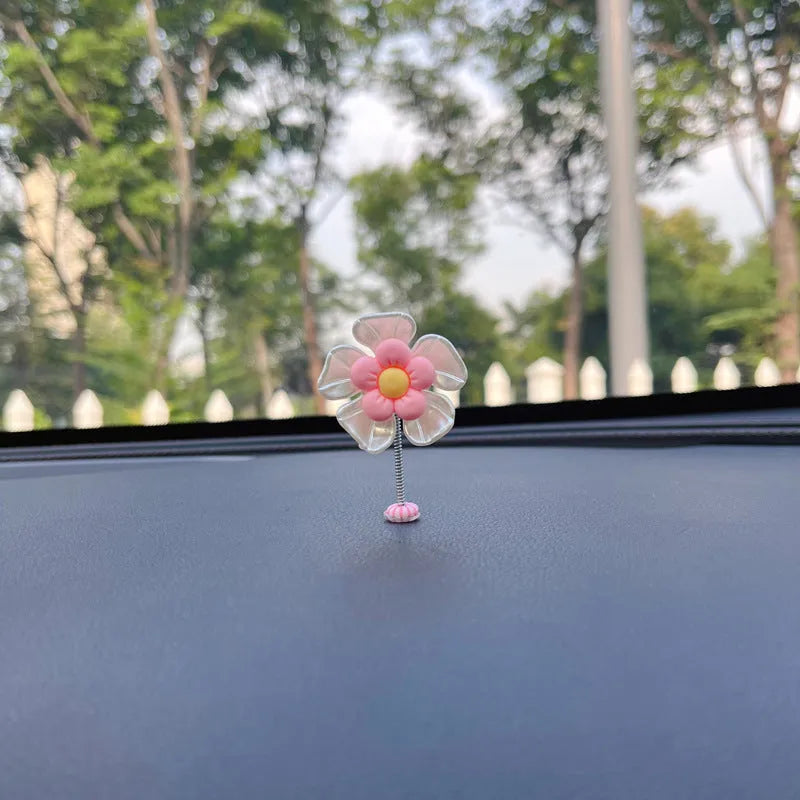 Small blue plastic swing ornament for car rear-view mirror, approx. 5cm tall.