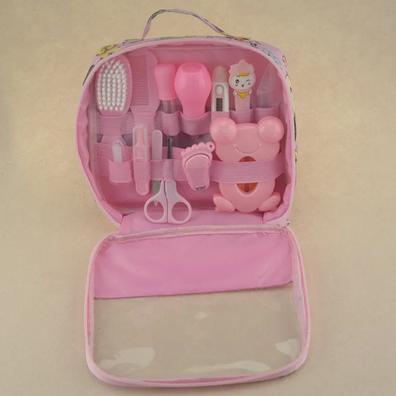 Roadfisher Newborn Baby Care Kit in pink or blue, showing safety scissors, brush, comb, thermometer, and syringe.