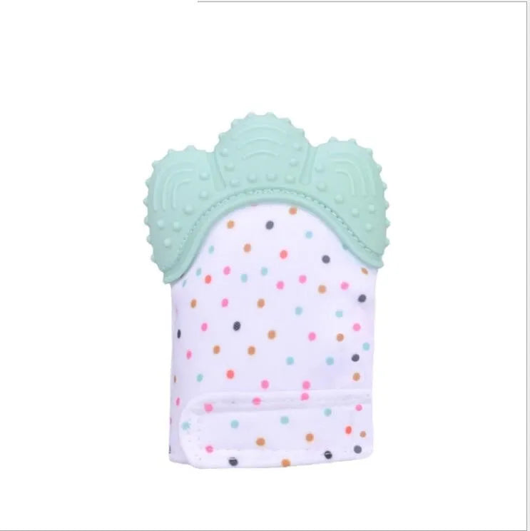 BPA-free silicone baby teether glove fastened with a white Velcro strap on a baby's hand