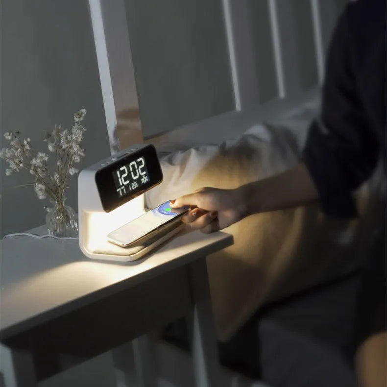 White bedside lamp with wireless charging pad and LCD clock display on base