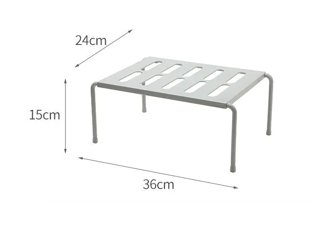 White telescopic plastic kitchen rack with single shelf, shown at adjusted height on a kitchen floor.