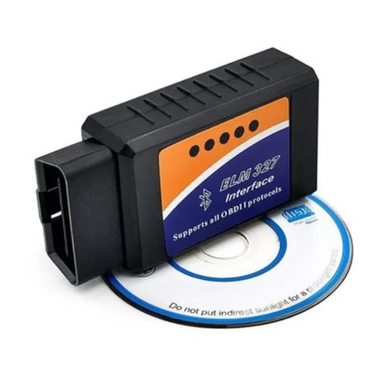 Small black OBD2 Bluetooth scanner car diagnostic code reader next to a vehicle's diagnostic port.