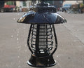 Black solar mosquito lamp with solar panel on top and LED lights for garden insect control