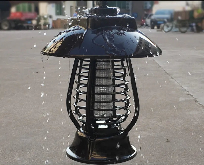 Black solar mosquito lamp with solar panel on top and LED lights for garden insect control