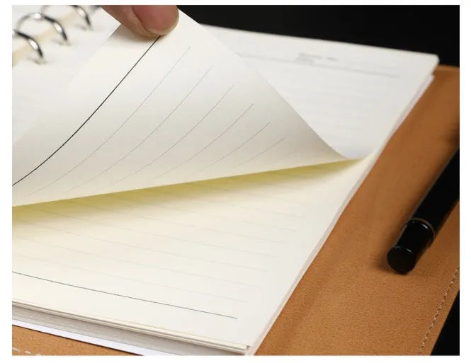 Hardcover A5 leather notebook with buckle closure in five colour options showing interior Daolin paper