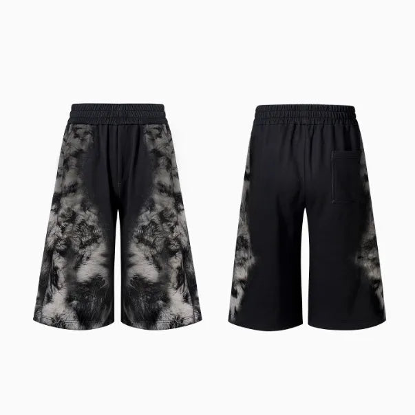 Streetwear co-ord set showing hoodie, full-length trousers, and seven-inch shorts with printed design and collage stitching detail.