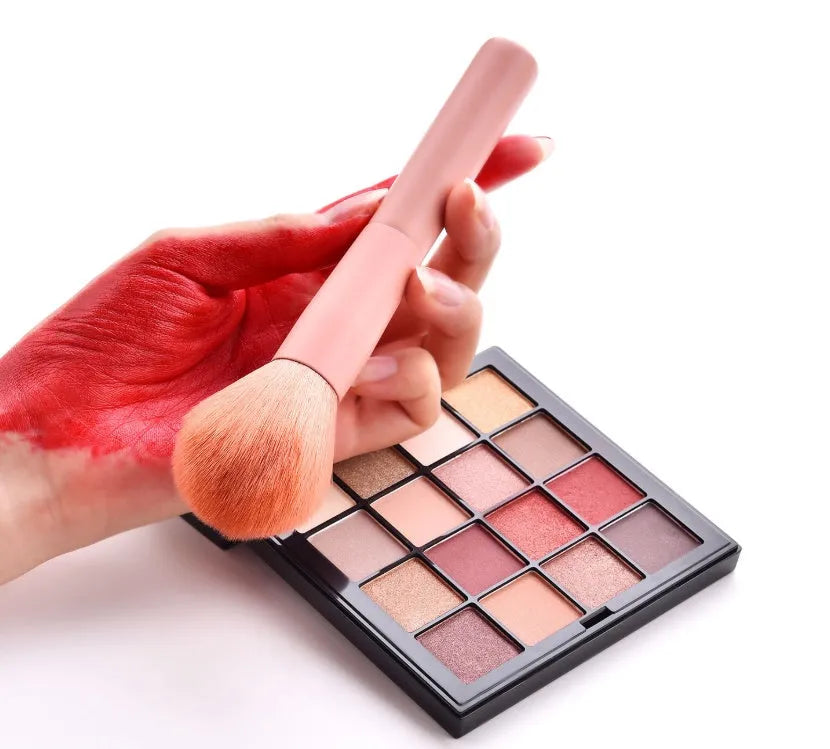 10-piece wooden handle makeup brush set including powder, foundation, eyeshadow, concealer, and lip brushes on pink background