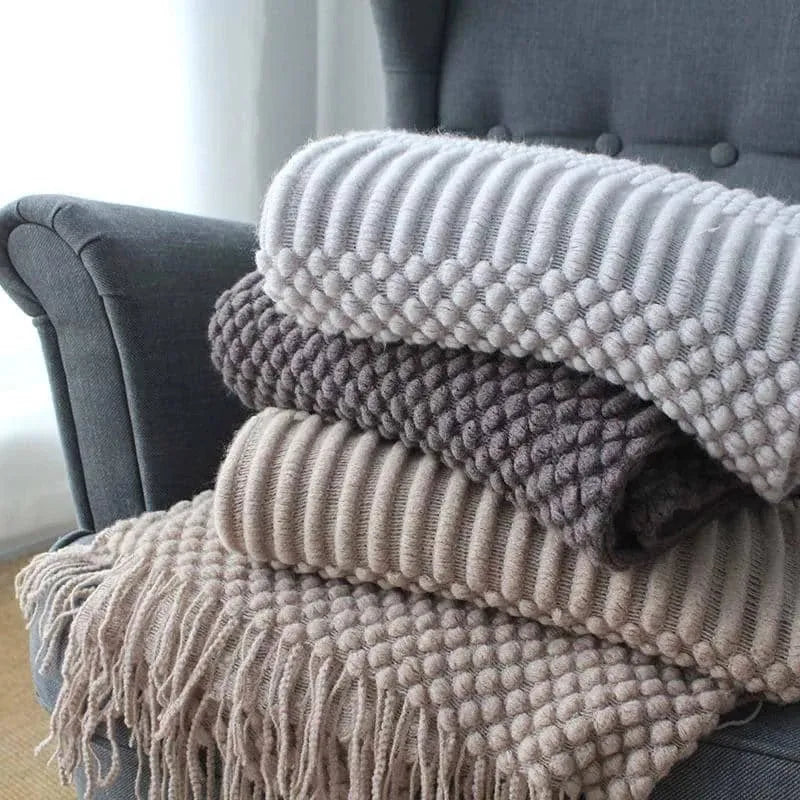 Small light grey polyester nap blanket folded, showing its texture and size.