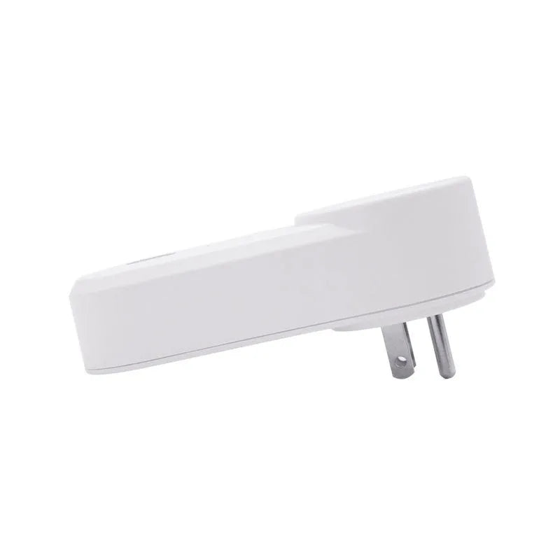 White Wi-Fi smart socket with UK 3-pin plug on a table next to a smartphone showing the ewelink app.