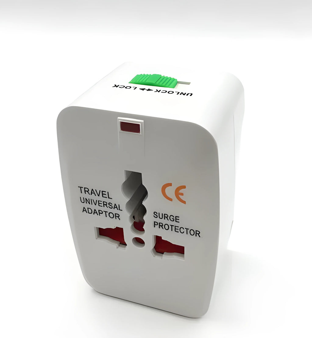 White universal travel plug adapter on a grey background showing its compact size.
