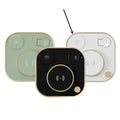 Black three-in-one wireless magnetic charging dock with desk lamp and USB port on a wooden desk.