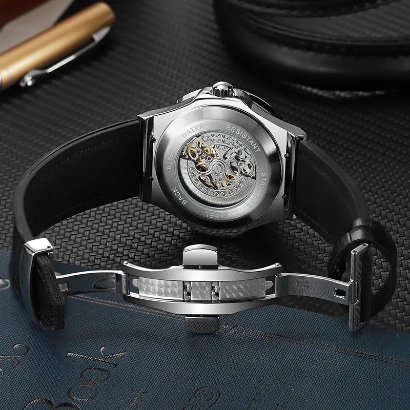 Men's automatic skeleton watch with diamond accents on a white metal case and strap.