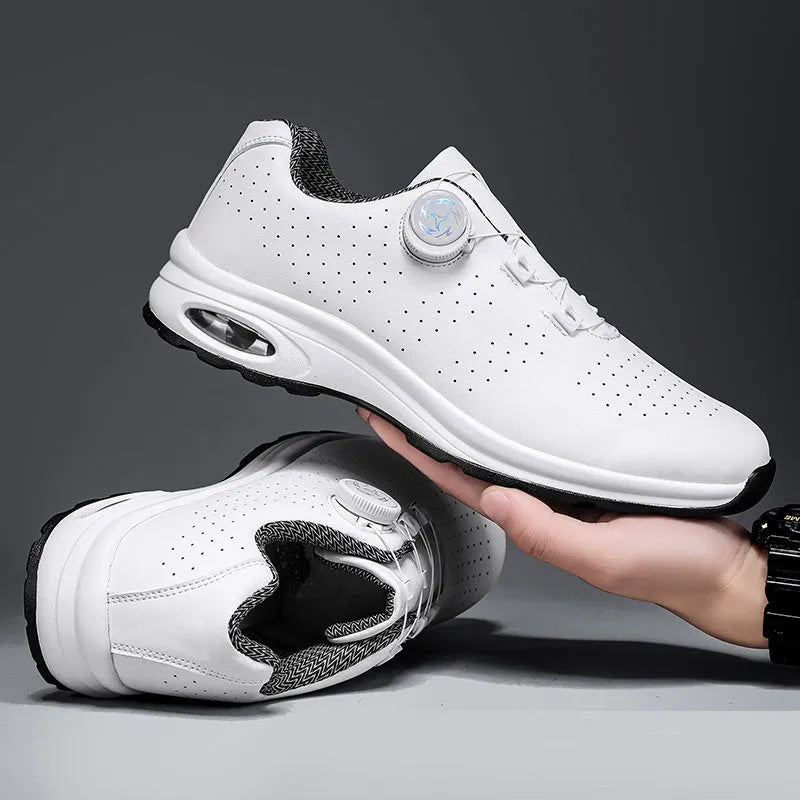Man's black and white low-top casual tennis shoes with mesh upper and cross shoulder straps.