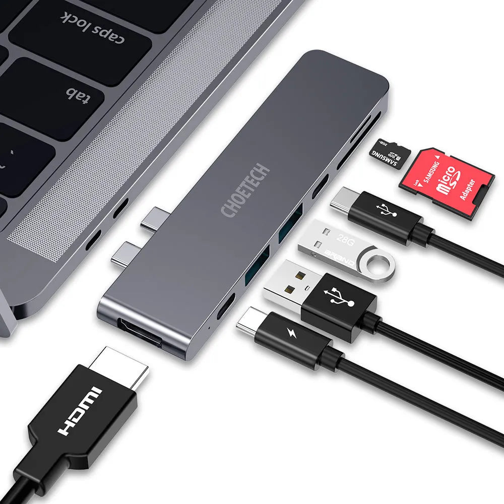 Silver aluminium USB C hub adapter with Thunderbolt 3, HDMI, SD card slots, and USB 3.0 ports