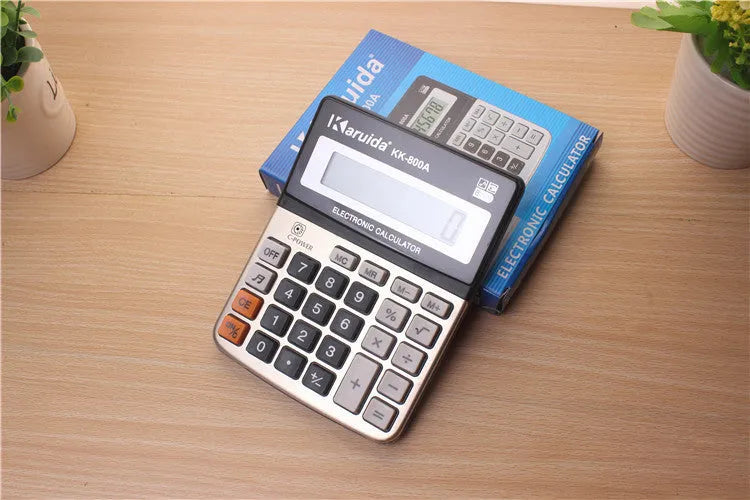 Silver aluminium desktop calculator with compact 14.5x11cm size on desk