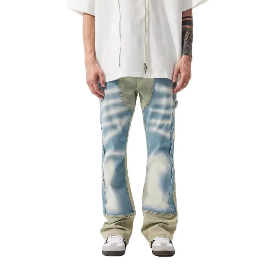Yellow and blue patchwork distressed denim jeans with a mid-rise waist and zip fly.