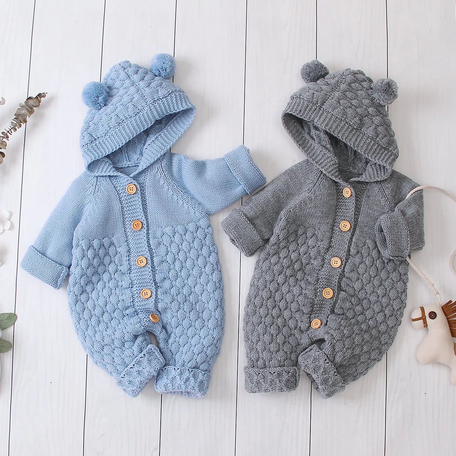 Hooded knitted jumpsuit in 100% acrylic fabric available in multiple colours with long sleeves