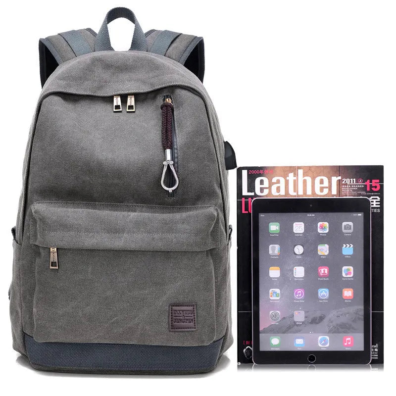 Canvas backpack with USB charging port shown in grey colour, featuring multiple pockets and straps.