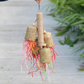 Shredded paper bird toy with colourful paper strips on wooden frame with sisal rope, measuring 15 by 35cm