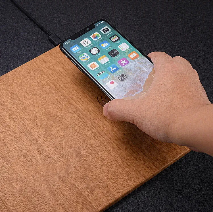 Wooden wireless charger with PU leather surface in brown finish on a desk