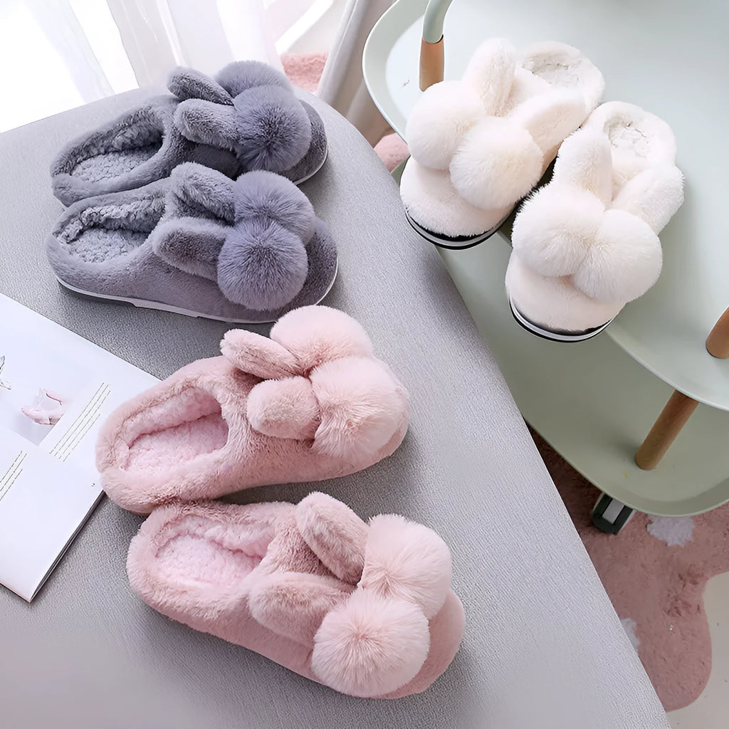 Women's fluffy rabbit fur slippers in pink, shown as slip-on winter shoes.