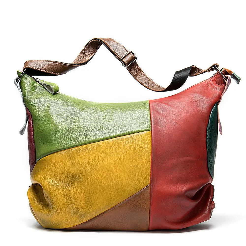 Brown cowhide leather crossbody travel bag open to show a 15-inch laptop and iPad inside.