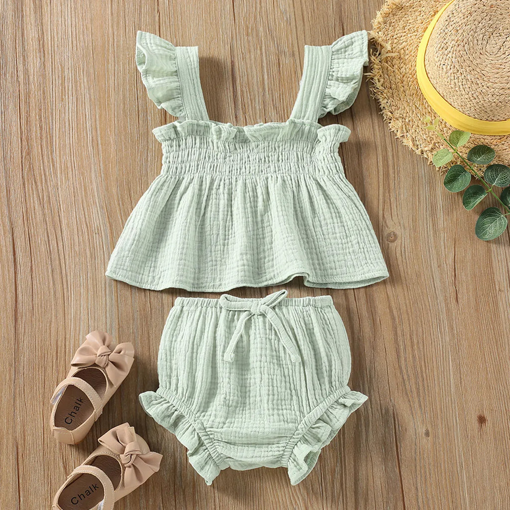 Green cotton girls' two-piece set with sleeveless sling top and matching short hot pants.
