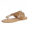 Women's black slip-on sandals with rhinestone details, a flip-toe strap, and a flat rubber sole.