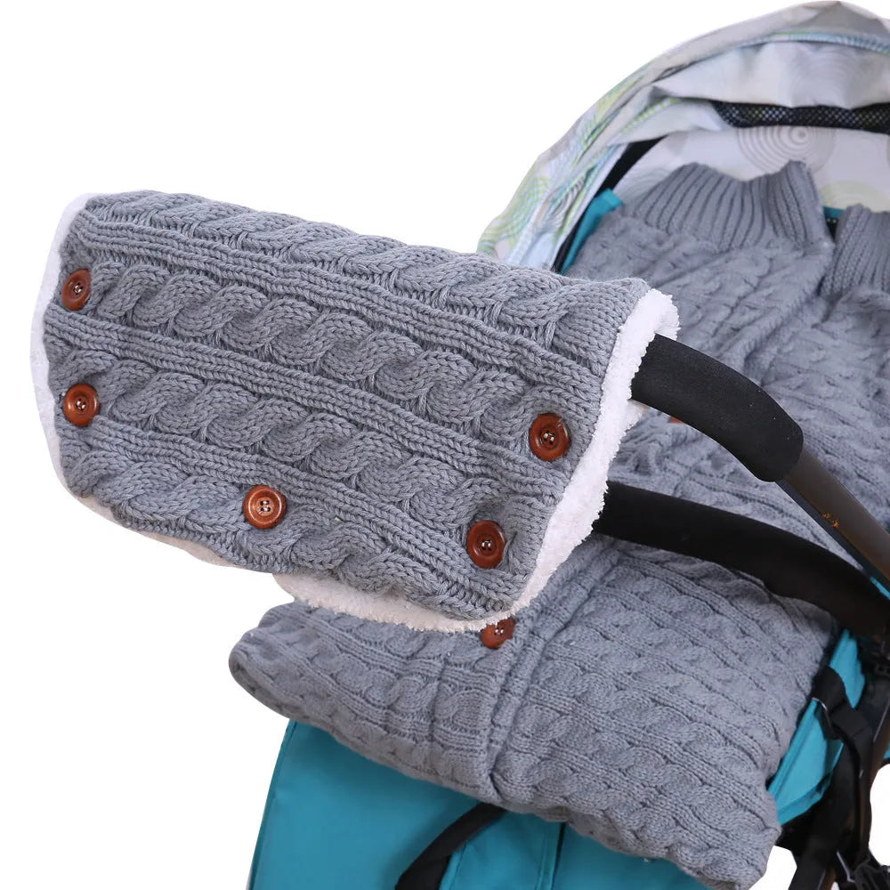 Baby sleeping bag in beige with lamb wool and acrylic material, button opening, and matching gloves on pram