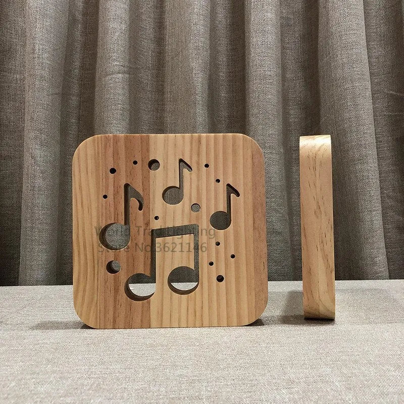 Wooden cube LED atmosphere lamp with warm white light on a desk, showing USB cable.
