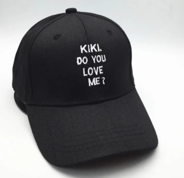 Letter embroidered cotton baseball cap in black with curved brim on white background