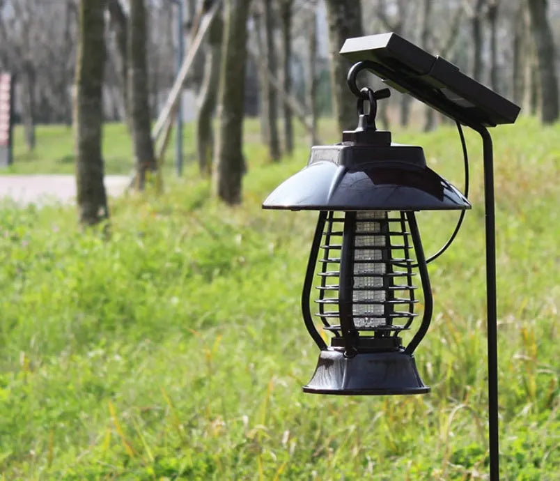 Black solar mosquito lamp with solar panel on top and LED lights for garden insect control