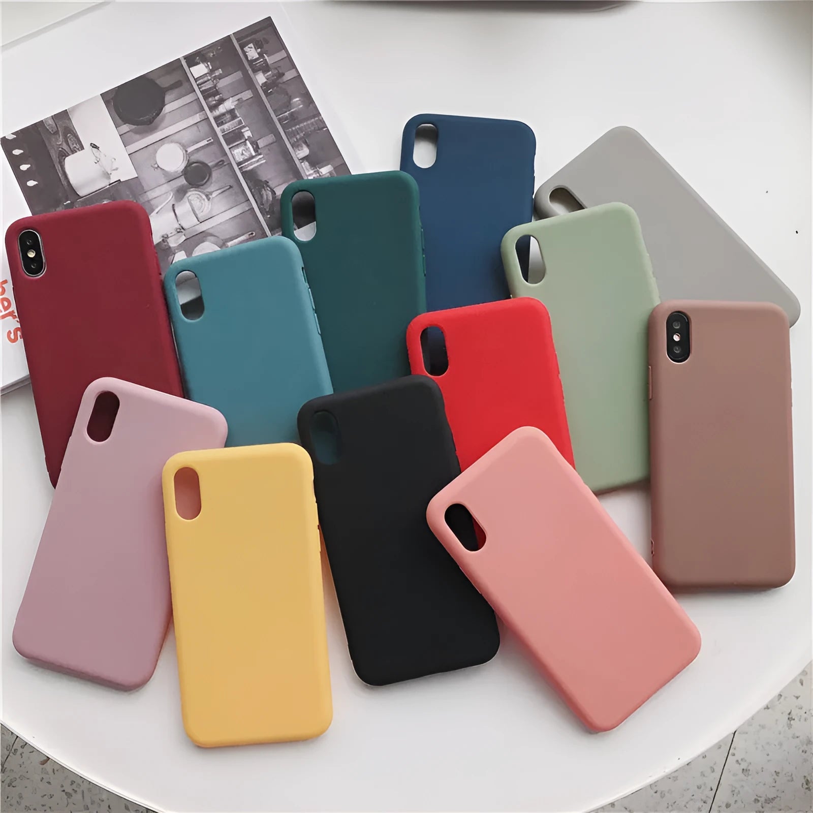 Silicone phone case for iPhone shown in multiple colours including wine red, light blue, and black.