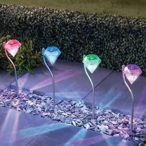 Solar-powered diamond-shaped garden light with solar panel on adjustable stake.