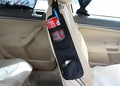 Black nylon car chair side bag with compartments for drinks and phone, attached to vehicle seat