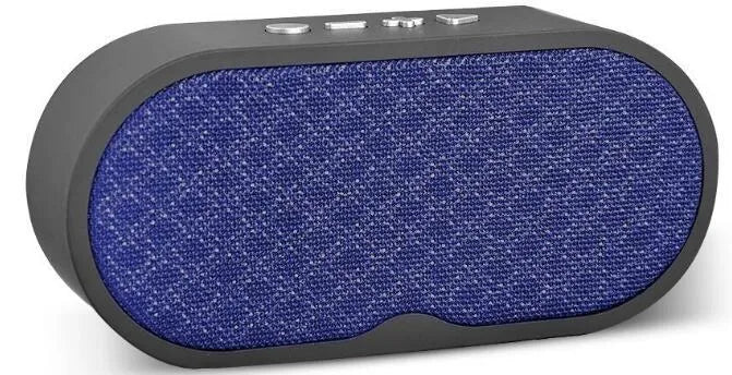 Portable grey Bluetooth wireless speaker with subwoofer and HD microphone on a table.