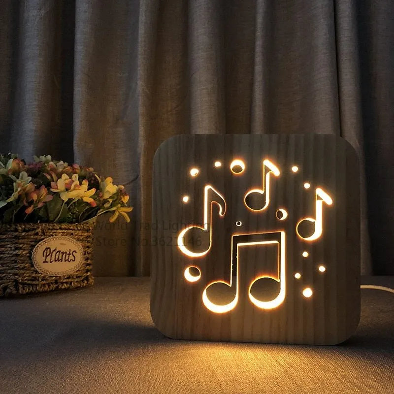 Wooden cube LED atmosphere lamp with warm white light on a desk, showing USB cable.