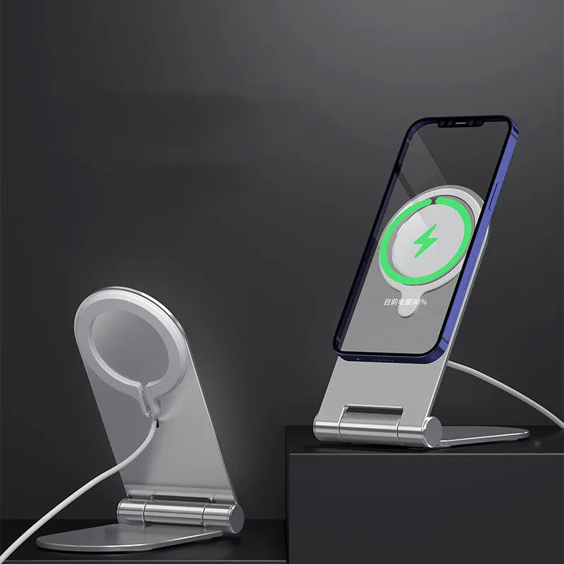 Silver aluminium alloy and plastic magnetic phone bracket for iPhone 12 on a desk.