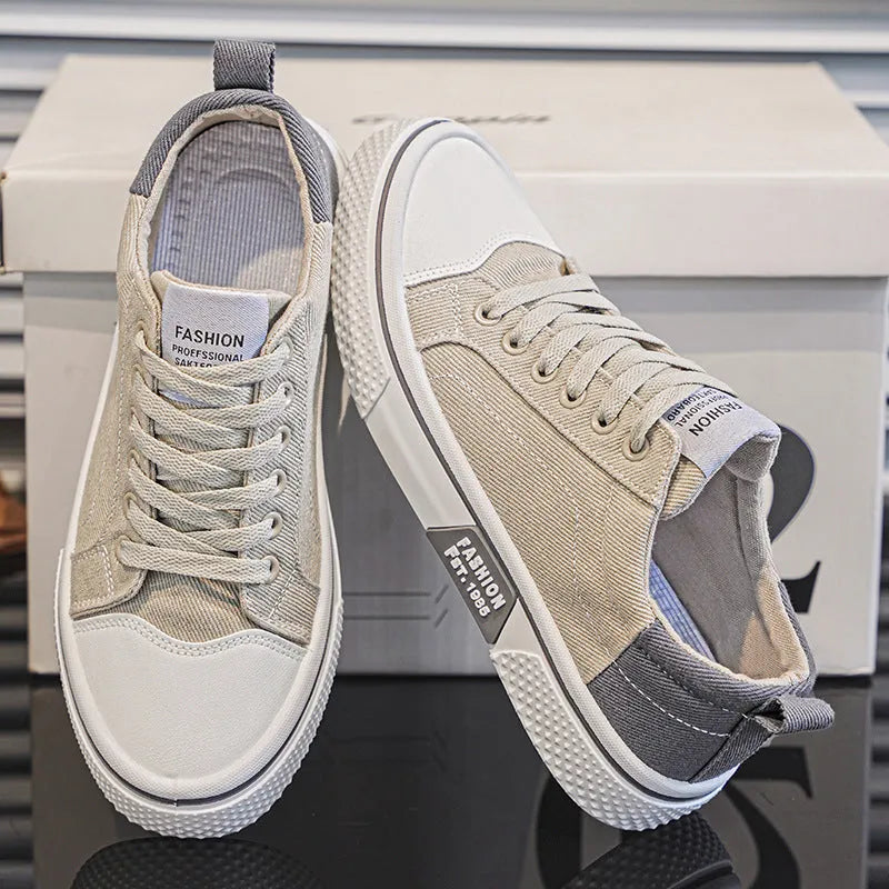 Men's blue low-top canvas casual sneakers with round toe and lace-up front on a white background.
