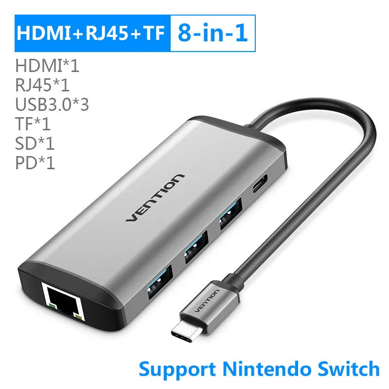 Deep grey aluminium alloy Type-C hub converter with HDMI, USB, Ethernet, and card reader ports.