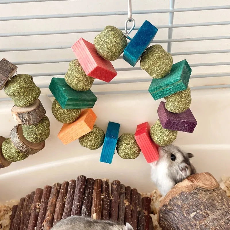 Hamster gnawing toy made of straw forming a ball ring, for small pets like guinea pigs.
